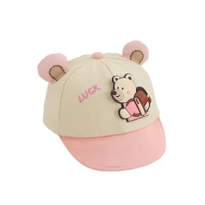 Beige baby baseball cap with cute bear patches and pink Luck embroidery detailing