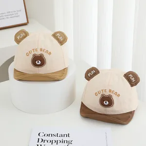 Detail of baby baseball cap with cute bear embroidery and 3D ears in cream and brown