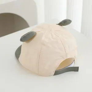 Detail of baby bear baseball cap showing adjustable velcro strap and premium cotton fabric