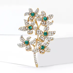 Floral crystal branch brooch with gold finish, sparkling rhinestones and green gems
