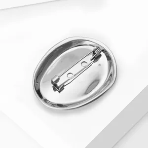 Detailed back view of a polished irregular geometric brooch with secure metal pin safety clasp