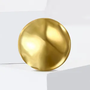 Detail of a liquid metal texture gold brooch with irregular wavy surface and matte finish