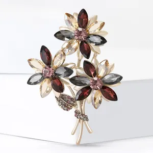 Elegant multi-color crystal floral brooch with golden plating and rhinestone leaves