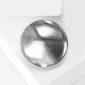 Macro view of a silver liquid metal brooch with irregular lava texture and mirror finish