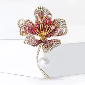 Elegant hibiscus flower brooch with pink rhinestones and a white pearl in gold finish