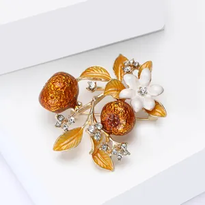 Chinese style persimmon brooch with amber fruit and white enamel flowers on gold stem