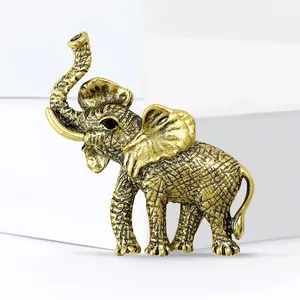 Exquisite antique gold elephant brooch with textured metal and black gemstone eye detail