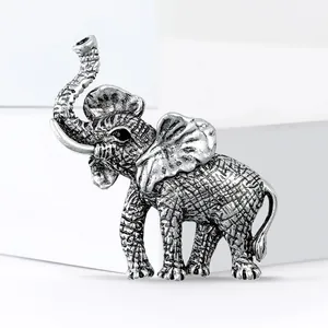 Vintage silver elephant brooch for suits featuring intricate carved mesh texture details