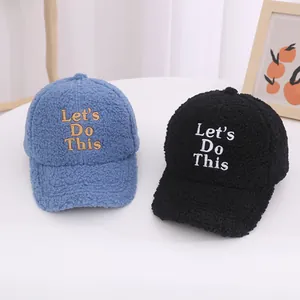 Detail of fleece baseball cap with Let's Do This embroidery in blue and black colors