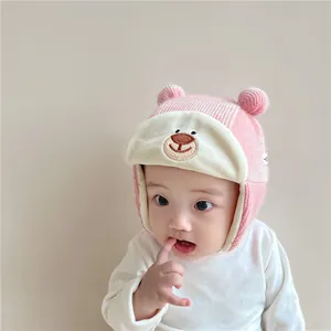 Pink knit baby winter hat with bear embroidery and cute ear flaps for ear protection