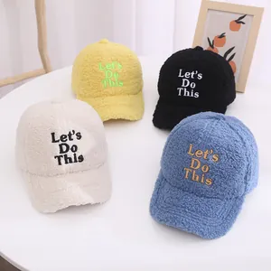 Detail of four fuzzy fleece baseball caps with Let's Do This embroidery in various colors