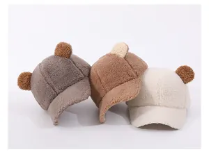 Detailed view of three plush baby baseball hats with bear ears in fleece material