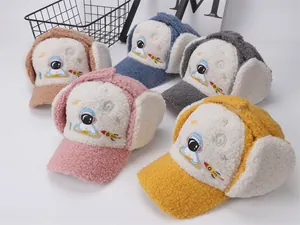 Detail view of colorful kids winter trapper hats with cartoon astronaut embroidery
