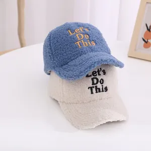 Detail of winter polar fleece baseball caps with embroidered letters in blue and beige