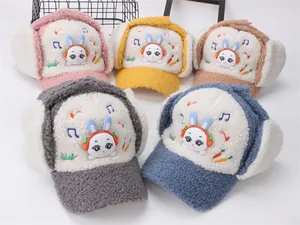 Detail of colorful plush winter ear-flap hats with cartoon rabbit design for kids