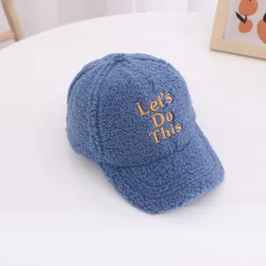 Detailed close-up of dark blue fleece baseball cap with Let's Do This gold embroidery