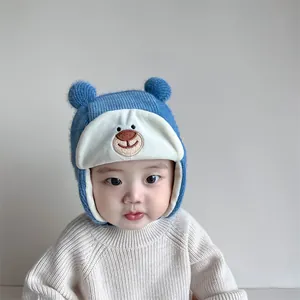 Detail of blue knit baby hat with bear ears and soft fleece lining for winter warmth