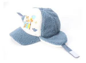 Detailed view of kids blue winter earflap hat with fluffy sherpa lining and rocket pattern