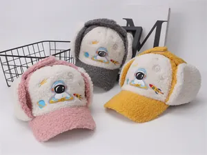 Detail of plush astronaut winter hats for children in pink, grey, and yellow colors