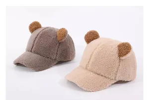 Close-up of thick sherpa baseball caps with bear ears in dark grey and beige colors