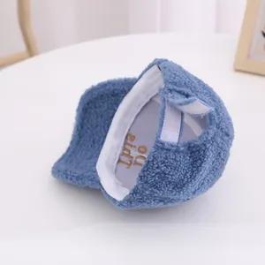 Detailed view of kids blue polar fleece baseball cap with gold embroidery and velcro strap