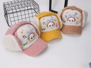 Close-up of warm winter earflap hats for kids with plush texture and rabbit embroidery