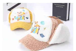 Detailed view of winter trapper hats with cartoon bear embroidery and fleece lining