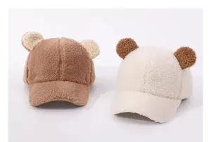 Detailed macro view of soft fuzzy teddy ears on plush winter baby baseball caps