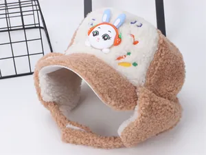 Detail of warm winter trapper hat for kids with cute bunny embroidery and earflaps