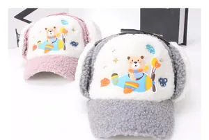 Detail view of winter cartoon pilot hats with soft fleece lining and ear flaps for kids