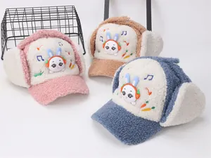 Detailed view of plush winter trapper hats for kids with bunny embroidery in three colors