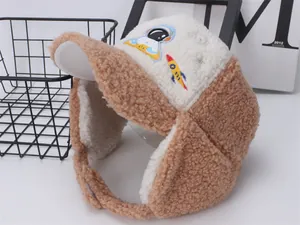 Detail of children's winter hat with astronaut embroidery and plush fleece texture