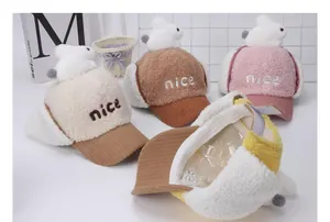 Detalle de gorros de invierno para niños con orejas de conejo y bordado de nice
