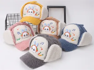 Detail of warm winter trapper hats for kids featuring rabbit patches in five colors