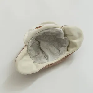 Detailed view of winter baby hat with soft grey plush lining and cute cartoon duck embroidery