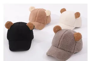 Close-up of fluffy winter baseball caps with cute bear ears in four different soft colors