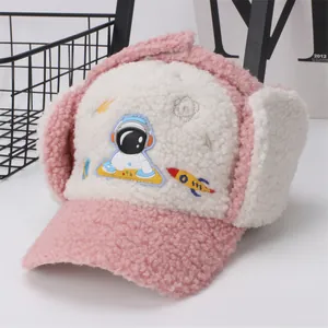 Pink and white sherpa aviator hat for kids featuring cute astronaut and rocket embroidery