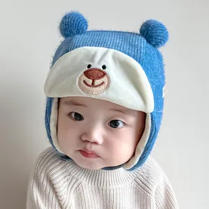 Winter baby aviator hat with blue pom-poms and cute bear embroidery for kids
