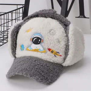 Detailed view of kids winter trapper hat featuring astronaut embroidery and fuzzy sherpa fabric