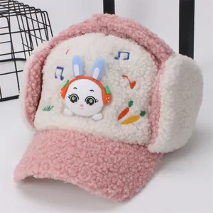 Close-up of pink and white plush earflap hat with 3D bunny and music embroidery
