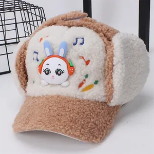 Winter plush trapper hat for kids featuring a brown rabbit with headphone embroidery