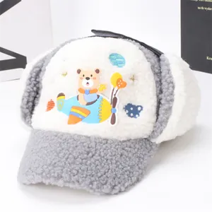 Winter windproof trapper hat for kids featuring a plush fleece bear and airplane motif