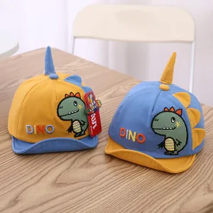 Detail view of cotton baby baseball caps featuring cartoon dinosaur embroidery and 3D horns
