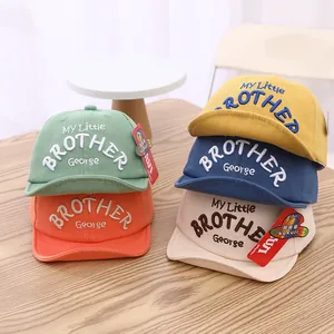 Close-up of soft cotton baby baseball caps in five colors with embroidered lettering