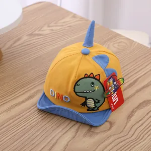 Detail of yellow cotton toddler baseball cap with dinosaur 3D horns and DINO embroidery