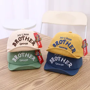 Detailed view of four colorful toddler baseball caps with brother george embroidery