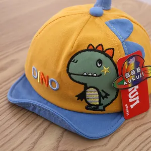 Detail of yellow and blue kids baseball cap with 3D dinosaur fin and dino embroidery