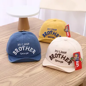 Solid color baby baseball caps with George embroidery in blue, yellow and beige