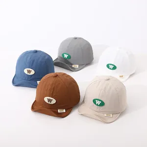 Collection of soft brim baby caps in navy, grey, white, caramel, and beige colors