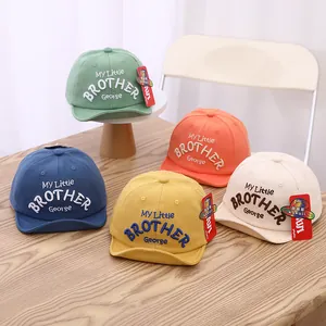 Detailed shot of five colorful cotton baby baseball caps with My Little Brother embroidery